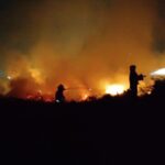 Bomberos Voluntarios de Funes combatiendo un incendio de pastizales de noche cerca del barrio Islas Malvinas