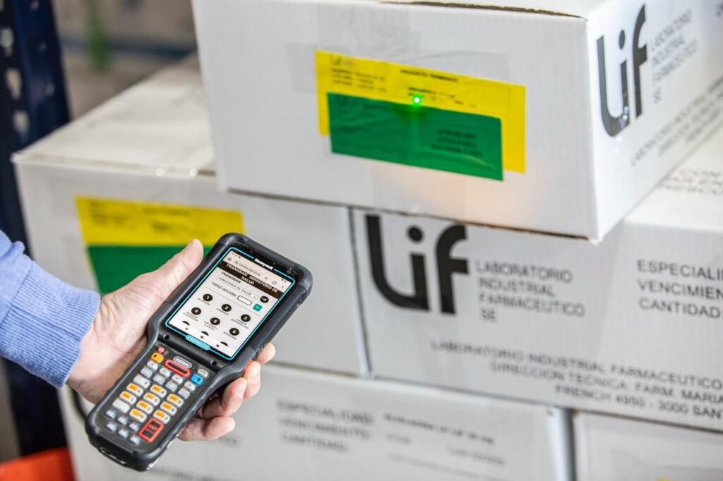 Logística de medicamentos en Santa Fe: operario escanea cajas del Laboratorio Industrial Farmacéutico en el depósito de Funes