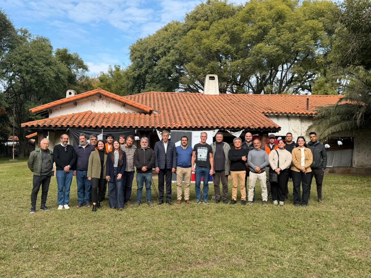 Foto grupal de funcionarios, integrantes de la Mesa Promotora y vecinos frente a la Quinta de Funes tras la firma del Acta