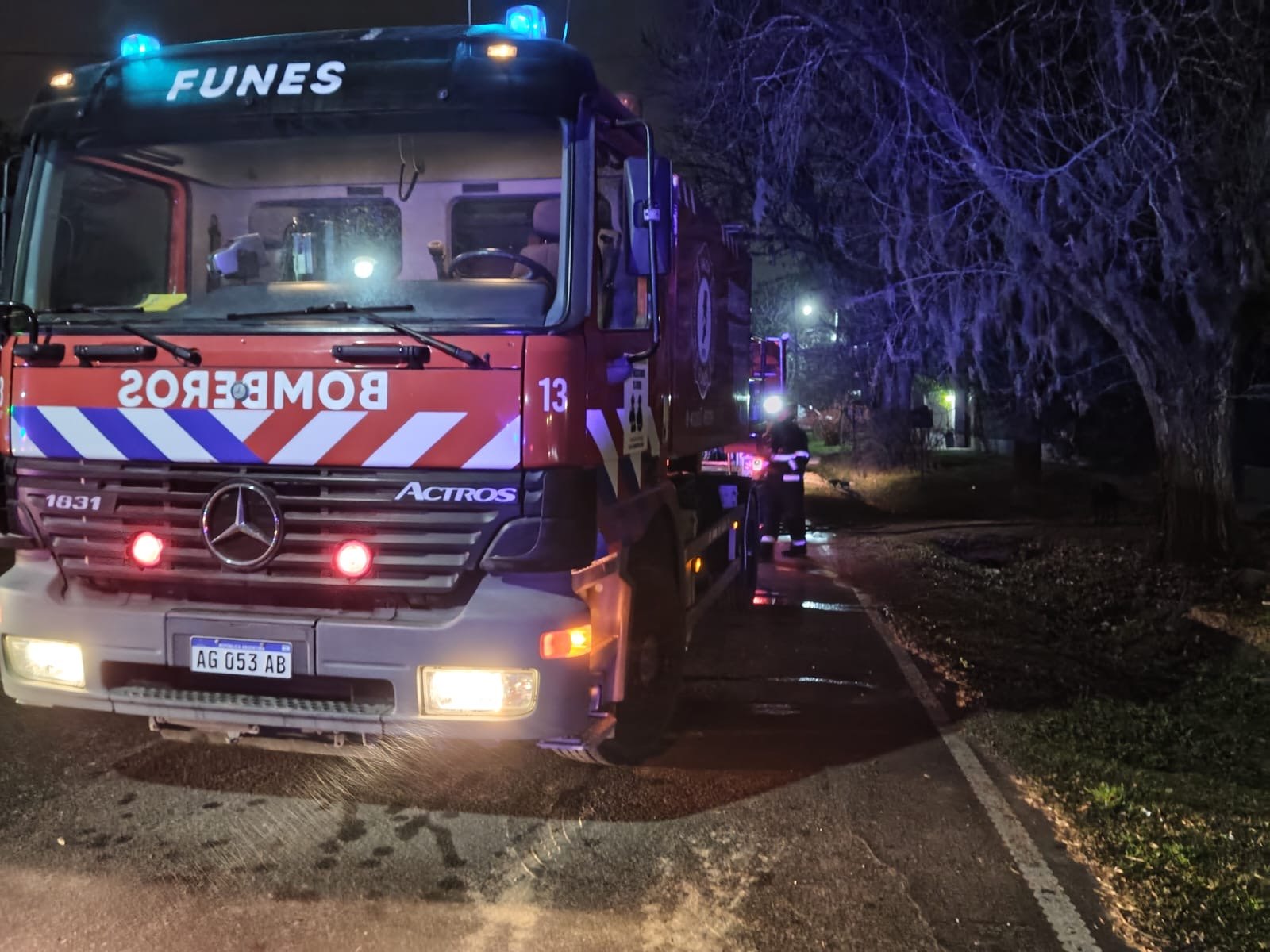 Un bombero trabaja junto a la autobomba durante el operativo por el incendio en Funes